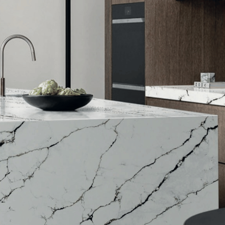 Luxury kitchen featuring white marble-look slab countertops and island by Builder Stone Global